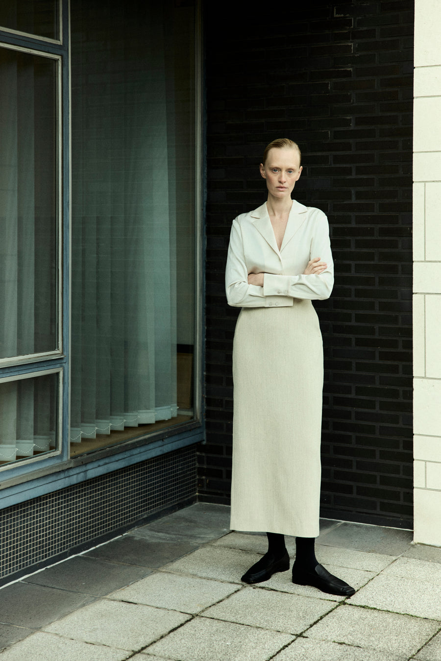 Luca wears the Elijah Shirt in Oyster, Innes Skirt in Bone & the Lane Loafer in Black