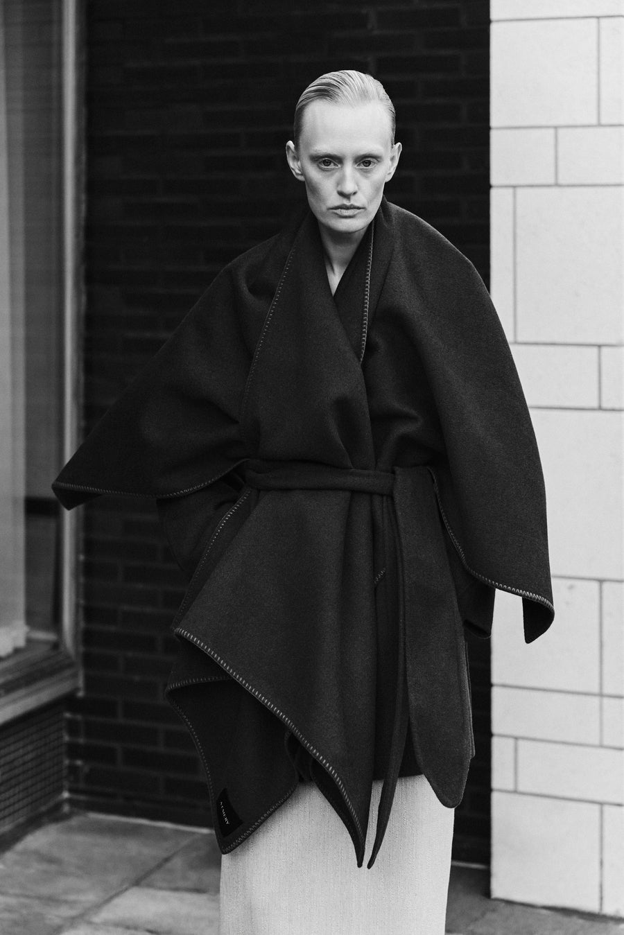 Luca wears the Lena Wrap belted over the Innes Skirt.