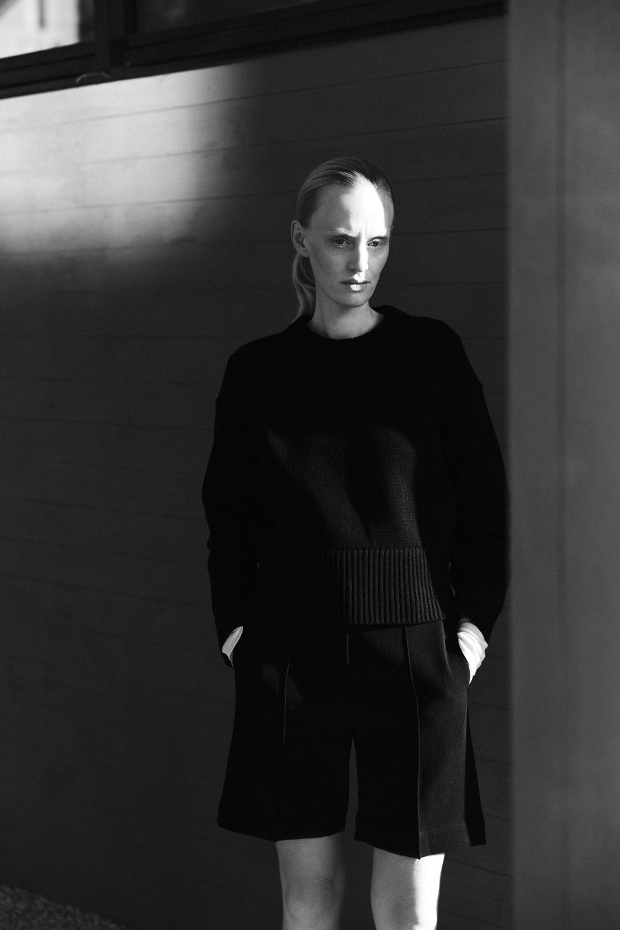 Luca wears the Orwell Knit in Black & the Keely Short in Black