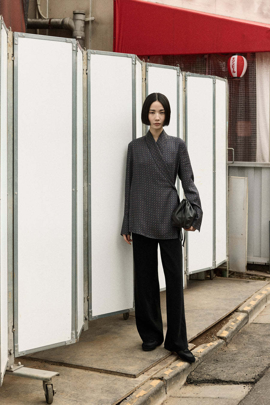 Tsugumi wears the Lea Shirt in Ink Foulard with the Angus Pant, Adams Low Sneaker and Tobey Bag.